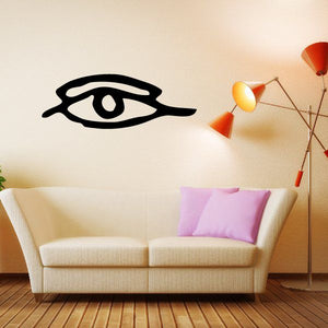 Egyptian eye decal looking left with closed lids, black graphic on flat surface