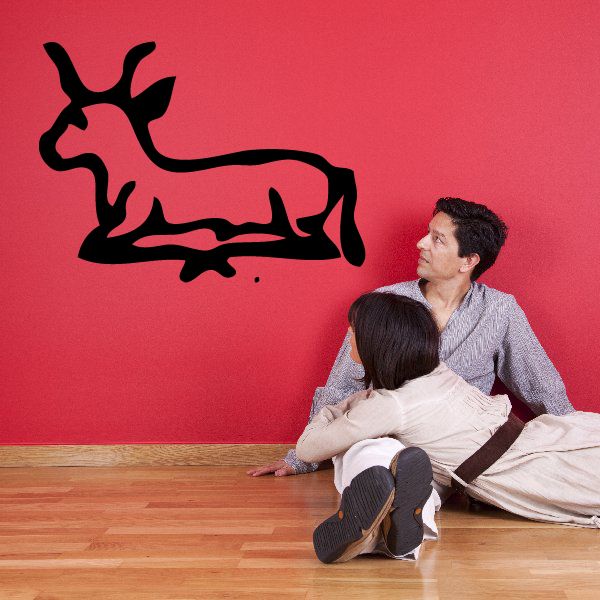 Laying bull wall decal in black silhouette with Egyptian hieroglyphic details