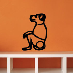 Black seated dog decal with stylized markings