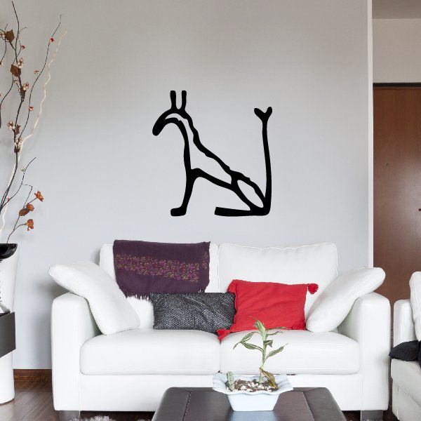 Seated giraffe wall decal with hieroglyph-style markings, black silhouette.
