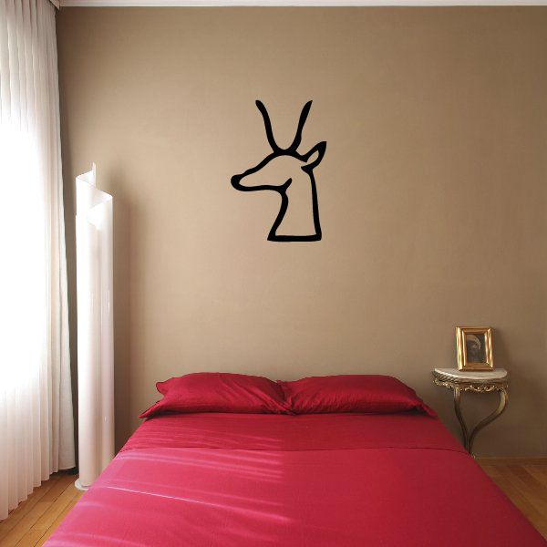 Egyptian hieroglyphics wall decal with black ankh-like symbol