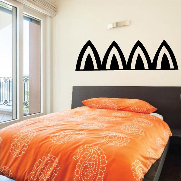 Egyptian wall decal with black repeating arch pattern on wall above bed