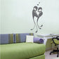 Love birds sticker with embracing birds and small hearts, black silhouette.