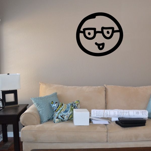 Black vinyl wall decal of a smiling cartoon face with glasses inside a circle