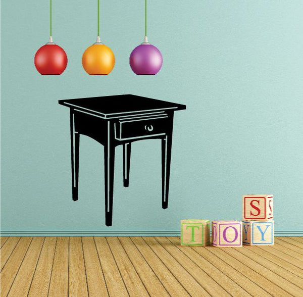 Black end table with drawer and decorative decal, four-legged side table