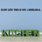 Enjoy Life wall decal with bold black quote: 'THIS IS NOT A REHEARSAL'.