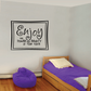 Black square wall decal reading 'Enjoy' and 'power and beauty of your Youth'