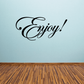 Black script wall decal reading “Enjoy!”