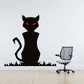 Black cat sticker with red eyes, sitting on grass