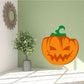 Evil jack-o-lantern sticker: orange pumpkin with green stem and carved grin