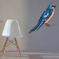 Exotic bird sticker with blue and orange bird perched on a thin branch