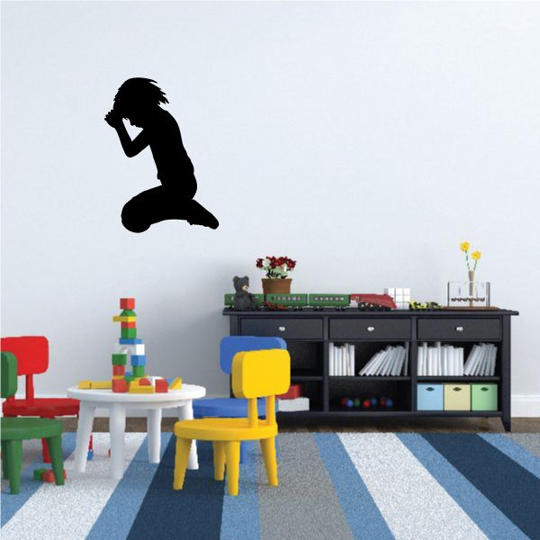 Black silhouette of a kneeling boy praying wall decal