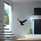 Black falcon silhouette decal centered on a light wall.