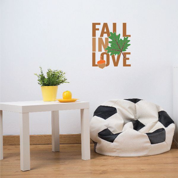 Die-cut wall decal printed with 'FALL IN LOVE' and a green leaf accent