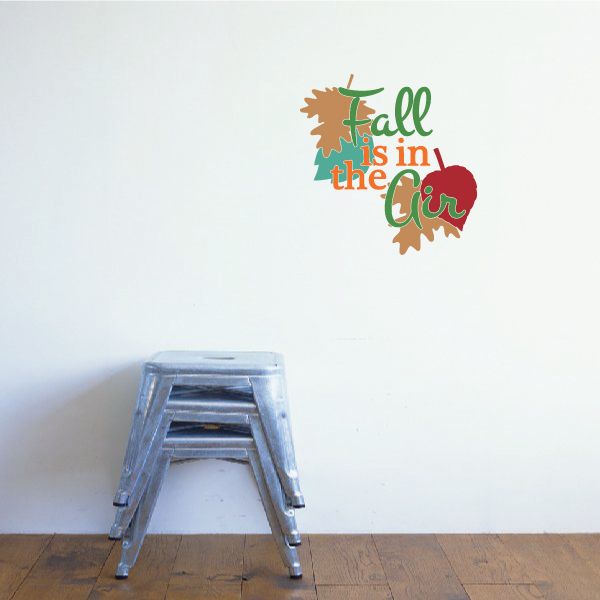 Die-cut wall decal: fall leaf graphic with text 'Fall is in the Air'.