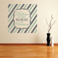 Christmas wall decal with striped background and “Believe in the Magic of Christmas” text