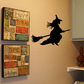 Flying witch silhouette decal on a broom, black cutout style.