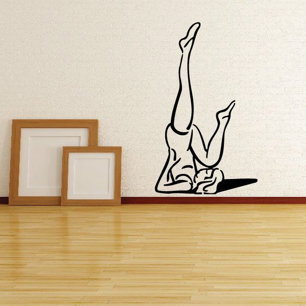 Black yoga wall decal of a stretching pose silhouette.