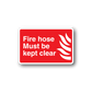 Red fire hose kept clear safety sticker with white text and flame icon