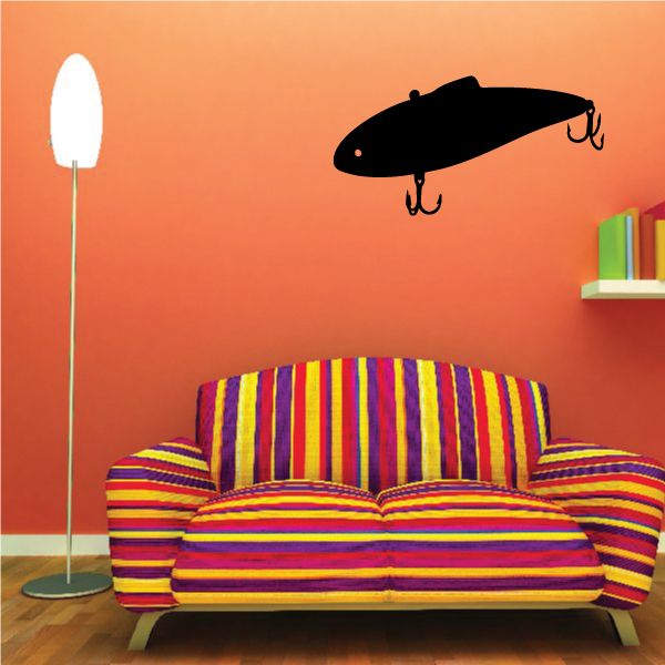 Fishing lure vinyl wall decal with black lure and hooks on orange wall