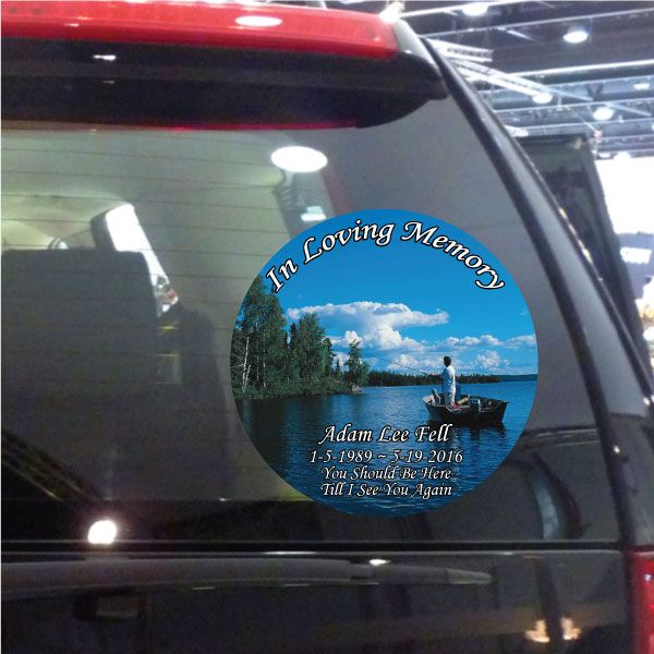 Round memorial circle sticker with blue sky, boat scene, and In Loving Memory text