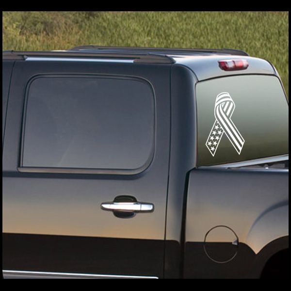 Flag ribbon decal with white ribbon and star accents on dark car body