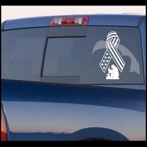 Kneeling soldier flag ribbon car decal, patriotic emblem design in white on dark surface