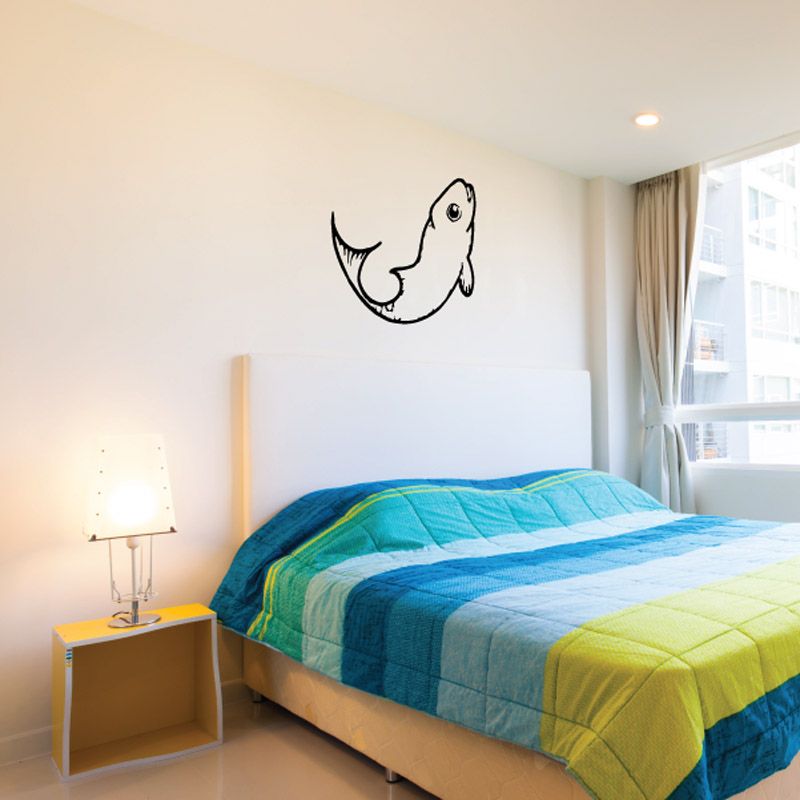 Flipping trout wall decal with black outline on a light wall