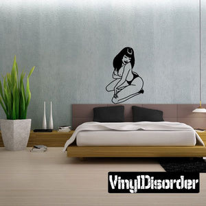 Seated woman vinyl decal with long hair, arms resting on knees, black line art