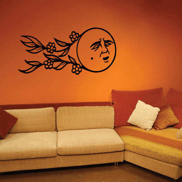 Black moon face wall decal with floating floral leaves and flowers