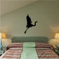 Black whooping crane wall decal with wings spread, floating above surface