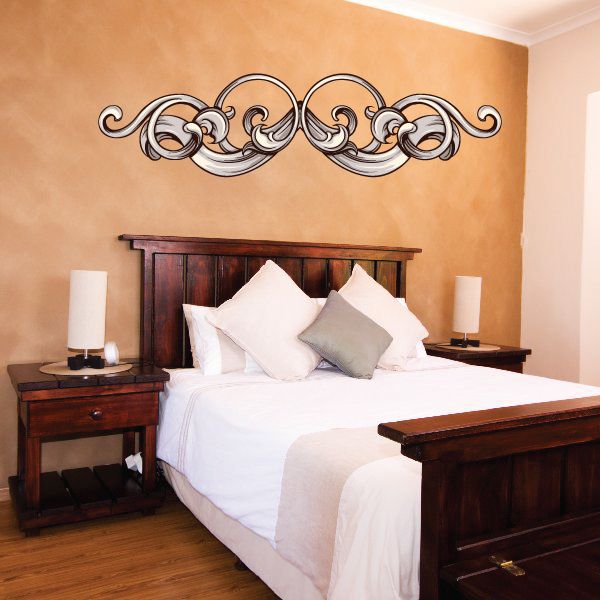 Floral scrollwork headboard wall decal with ornate black and gray vine design