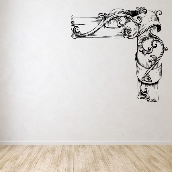 Ornamental vinyl wall decal with floral scroll corner design, arched ribbon and leaves