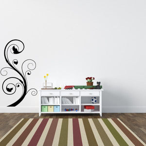 Black floral swirl wall decal with circular flourishes and leaf