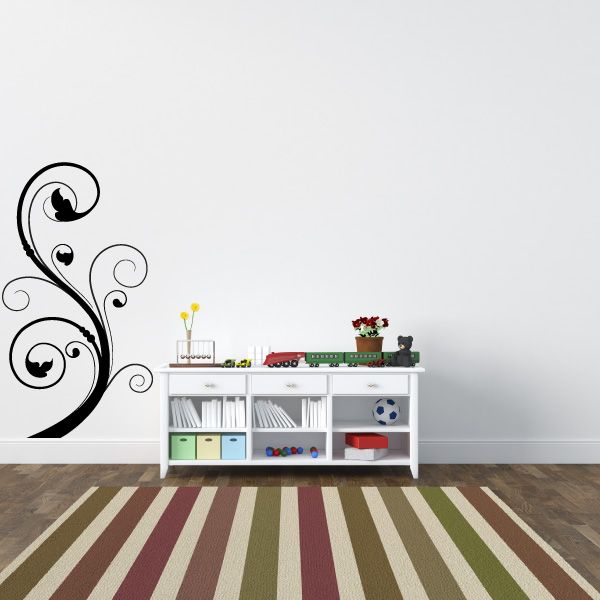 Black floral swirl wall decal with circular flourishes and leaf