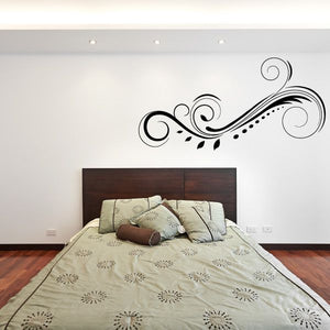 Black ornamental swirl wall decal with curved flourishes and dotted accents