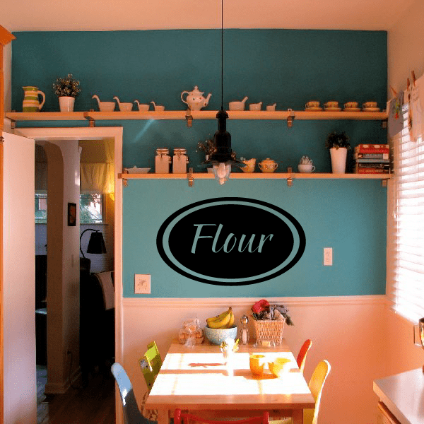 Flour oval decal, black oval with white script text on a light wall