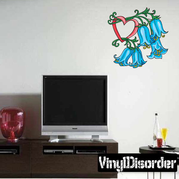 Flower and heart wall sticker with blue blooms, red heart, and green accents