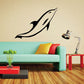 Black dolphin swimming wall decal with curved fins and tail
