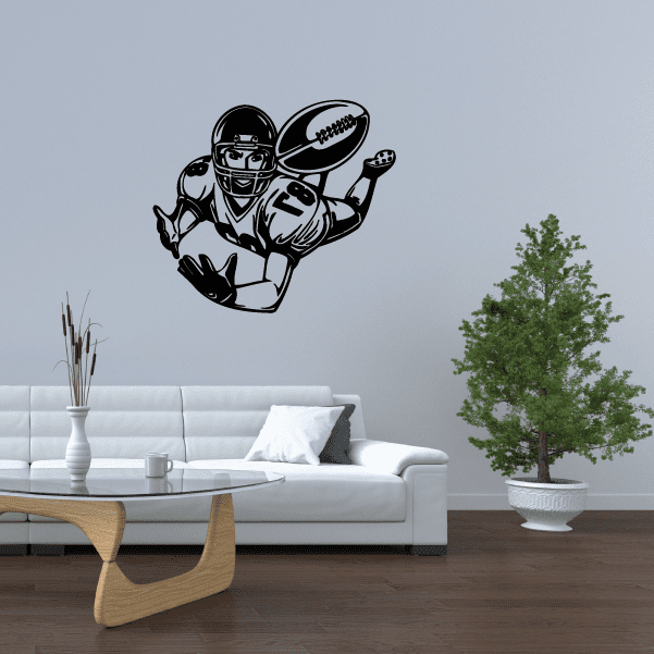 Football player wall decal, black vinyl of a helmeted player holding a football.