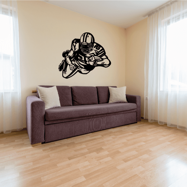 Football player wall decal, black vinyl of helmeted player running across wall