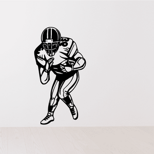 Football player vinyl wall decal of a black-outlined football player in a throwing stance
