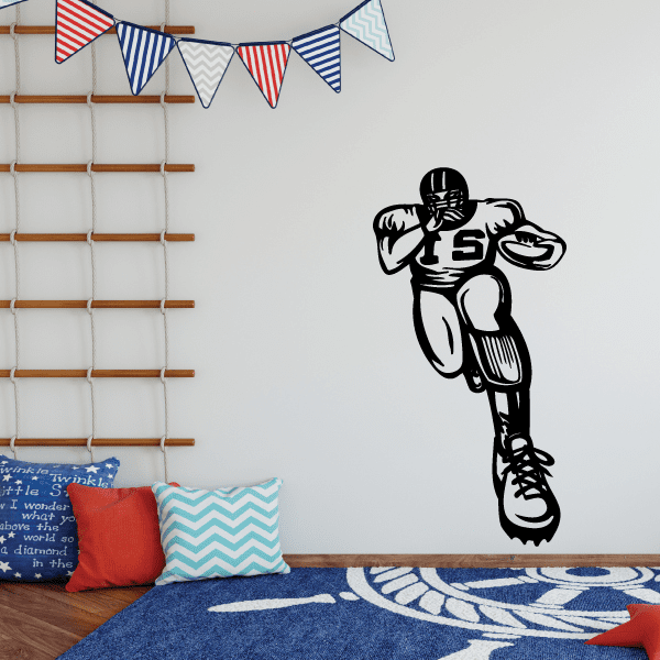 Black football player wall decal with helmet and jersey number 5 holding a ball