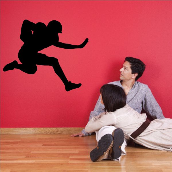 Football player wall decal, black silhouette of a kicking athlete