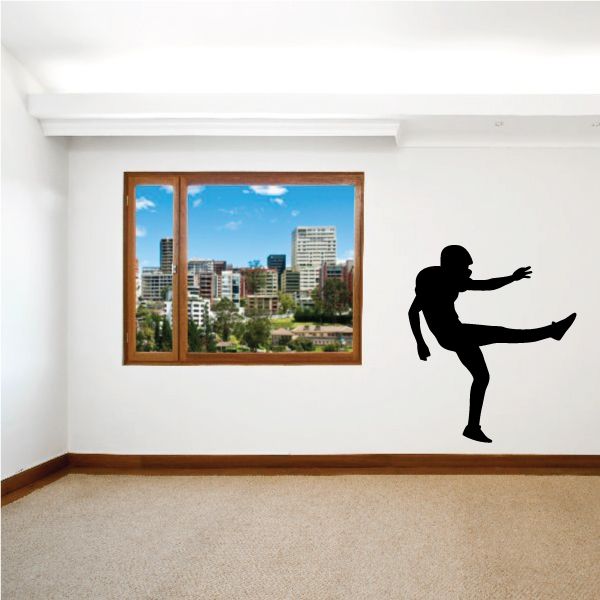Black football player wall decal silhouette, kicking pose on vinyl
