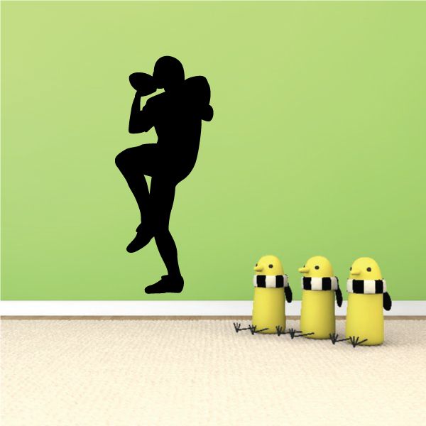Football player vinyl wall decal, black silhouette in kicking pose