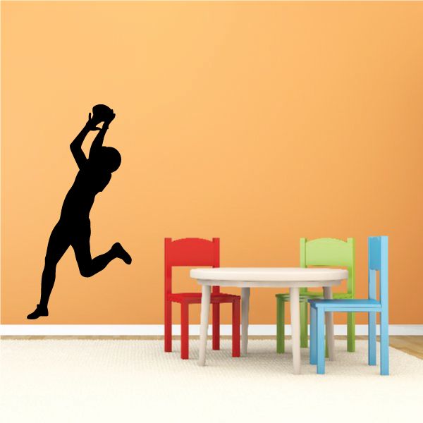 Football player wall decal, black vinyl silhouette of a kicking runner.