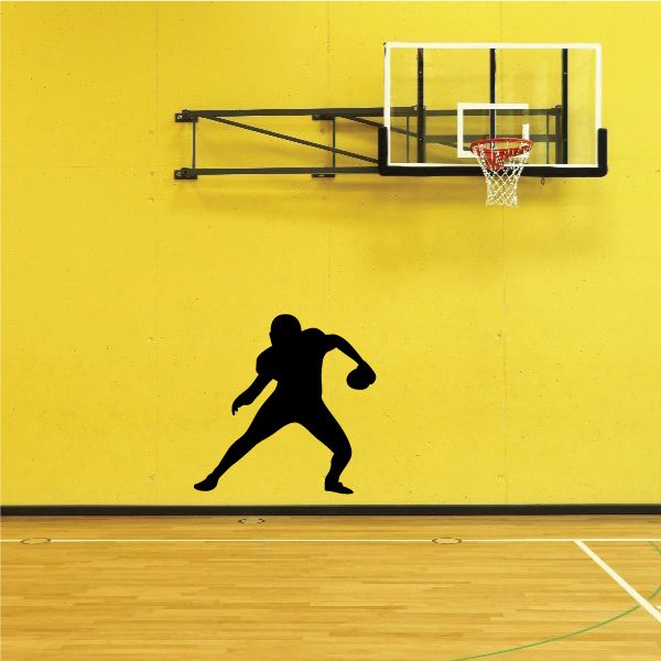 Football player wall decal, black silhouette of a kicking football player.