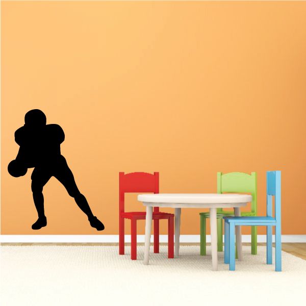 Football player wall decal, black vinyl silhouette running with ball