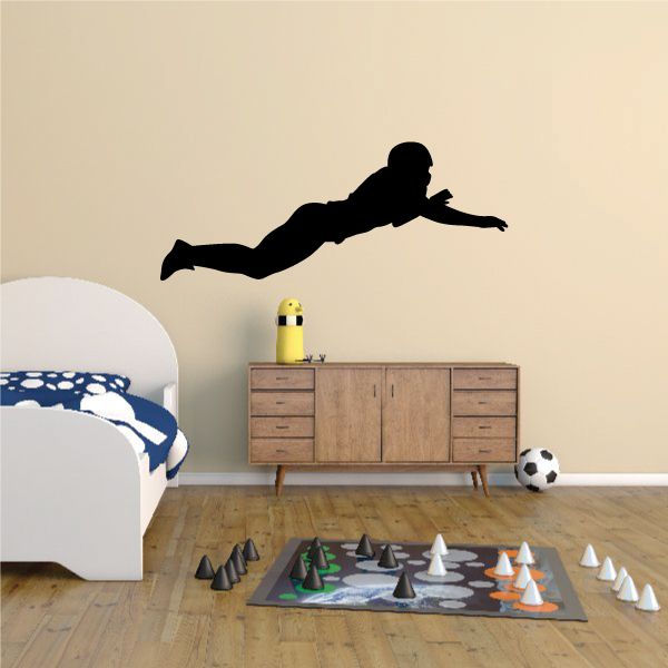 Football player wall decal, black vinyl silhouette in mid-kick pose